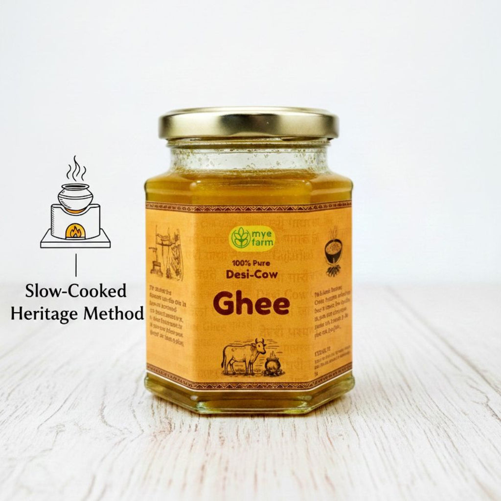 Mye Farm 100% pure desi cow ghee in glass jar, prepared using a slow-cooked traditional heritage method, showcasing golden handmade ghee on a clean wooden background
