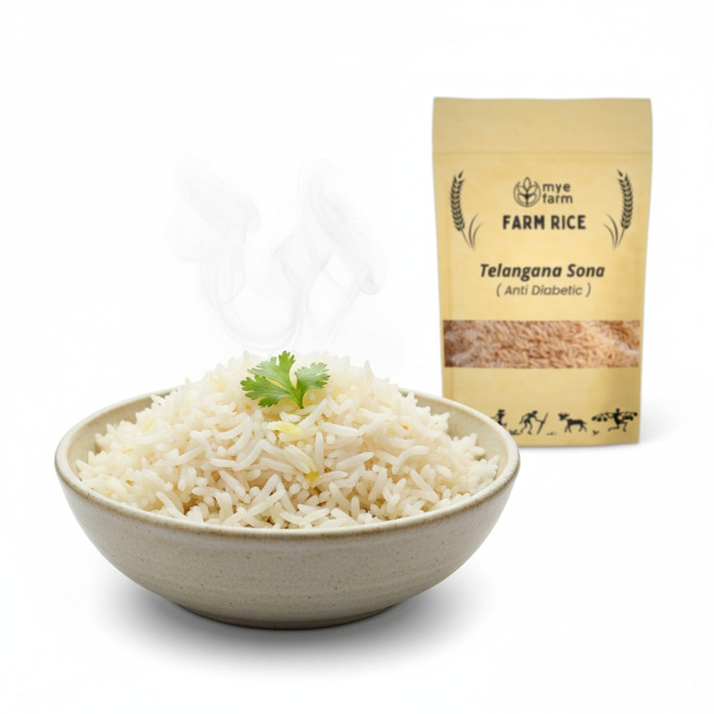 Serving suggestion for Mye Farm Telangana Sona Rice. A bowl of freshly cooked, steaming, fluffy white rice is shown in the foreground with the product packaging visible behind it. Highlights the light, non-sticky texture.