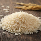 Close-up macro shot of Mye Farm Telangana Sona Rice raw grains piled on a rustic wooden surface, emphasizing the natural, unpolished texture and creamy white color of the low GI rice.